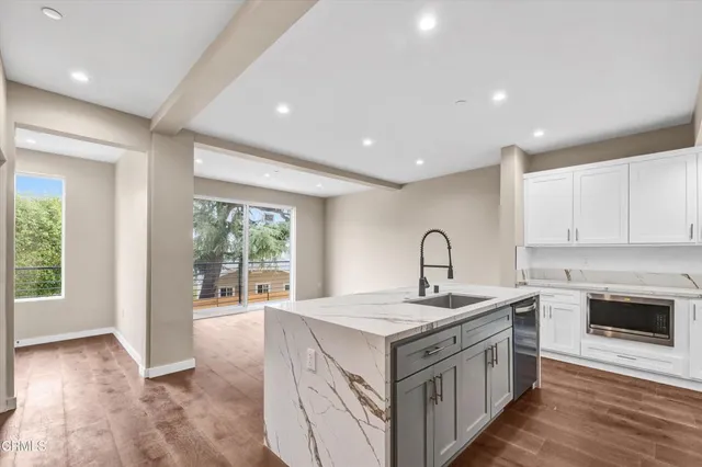 a kitchen that has a sink and a stove in it