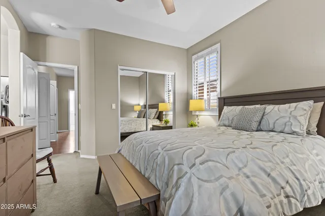 a bedroom with a bed and a mirror