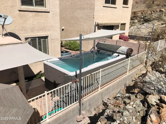 a view of balcony with wooden floor and seating space