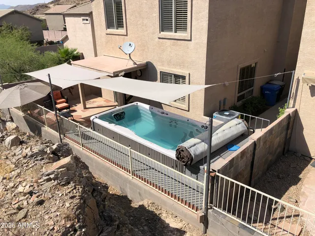 a roof deck with couches and wooden floor