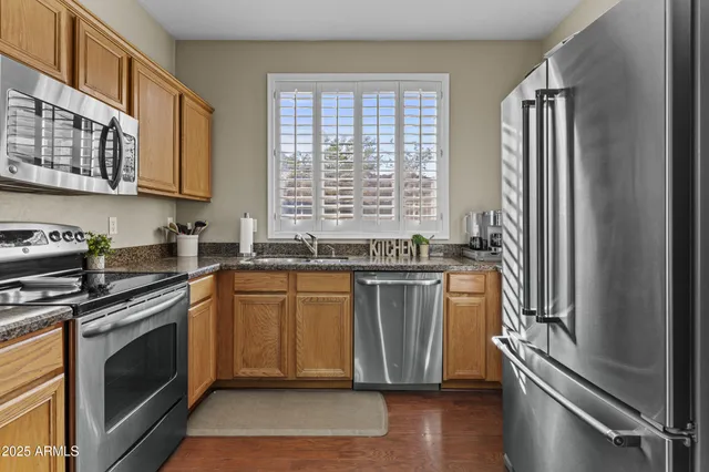 a kitchen with granite countertop a stove and a sink