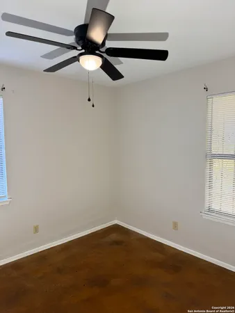 a view of room with hardwood floor and ceiling fan