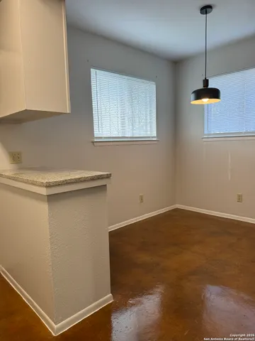 a view of empty room with windows and fan
