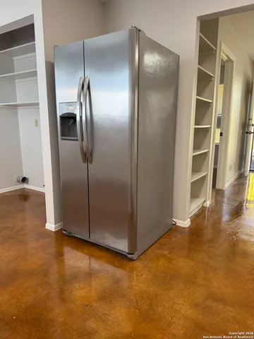 a view of an empty room with closet area