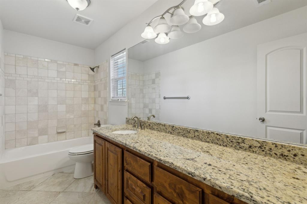 233 Firefly Drive Springtown, TX 76082 - Photo 13 of 16 Bathroom featuring granite countertops and shower tub combo.