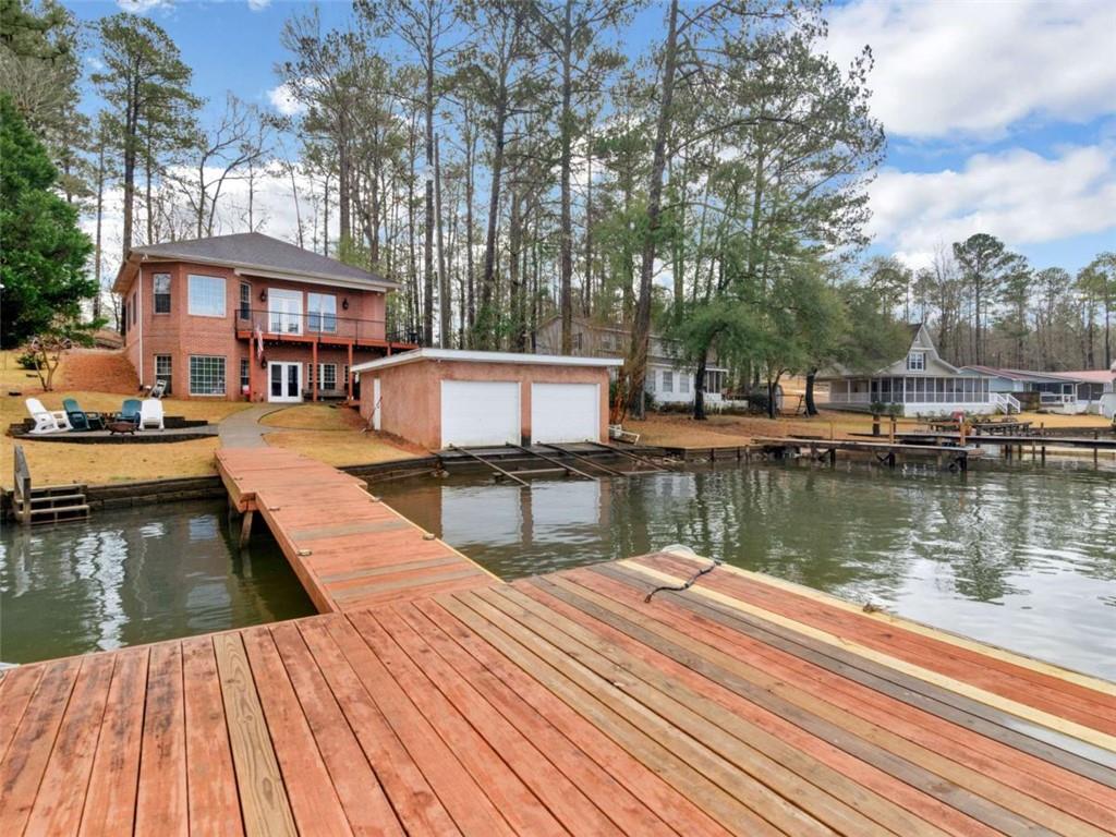157 Andrea Circle Jackson, GA 30233 - Photo 2 of 19 a view of a house next to a lake with a large trees