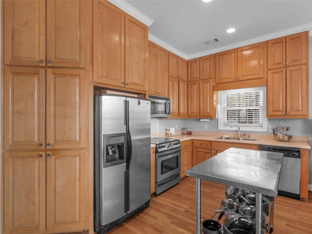 157 Andrea Circle Jackson, GA 30233 - Photo 4 of 19 a kitchen with stainless steel appliances granite countertop a refrigerator a sink dishwasher a stove and a refrigerator with wooden floor