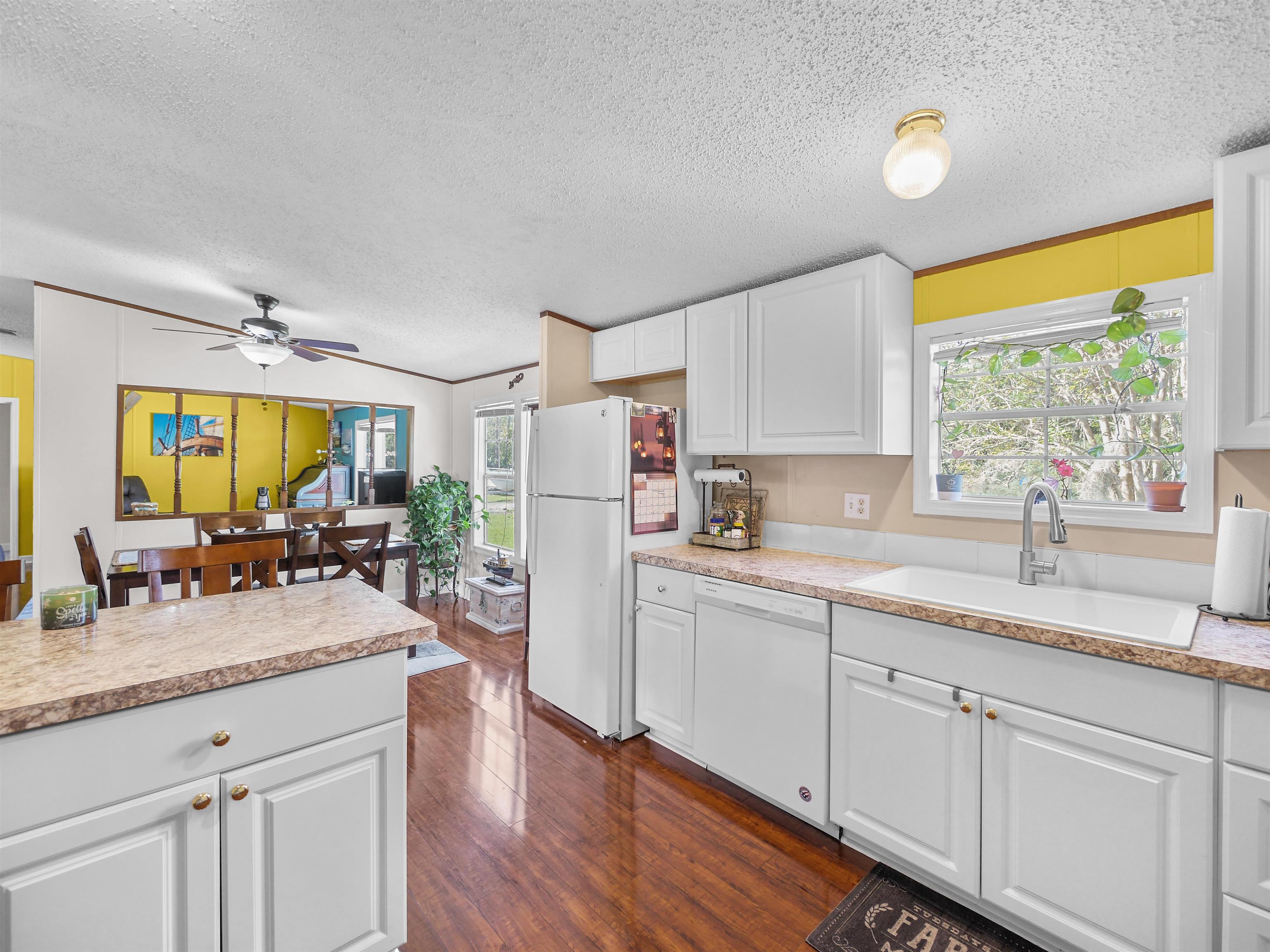 2961 Race Track Road St. Augustine, FL 32084 - Photo 11 of 42 a kitchen with sink refrigerator and window