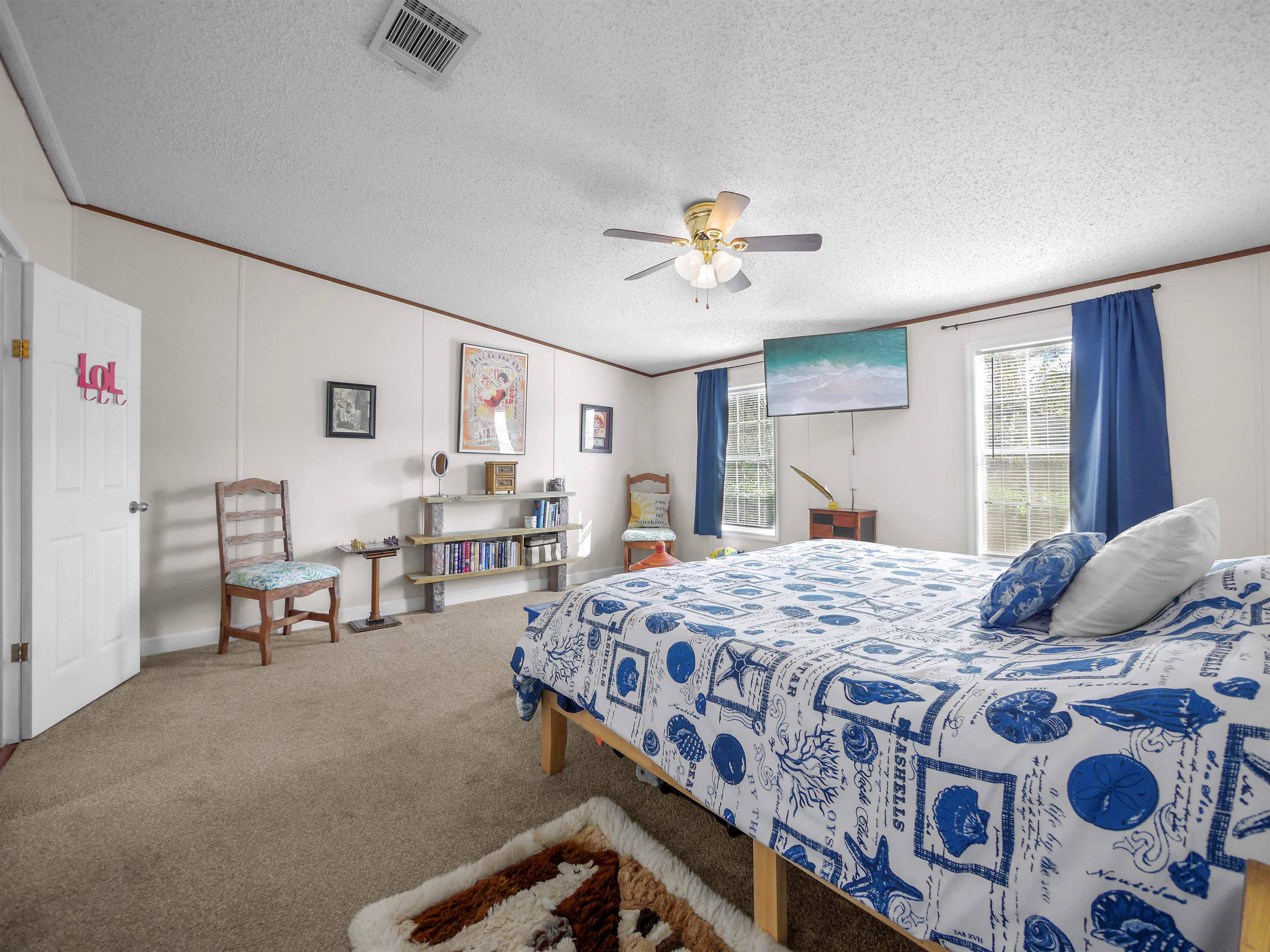 2961 Race Track Road St. Augustine, FL 32084 - Photo 15 of 42 a bedroom with a bed and a chandelier