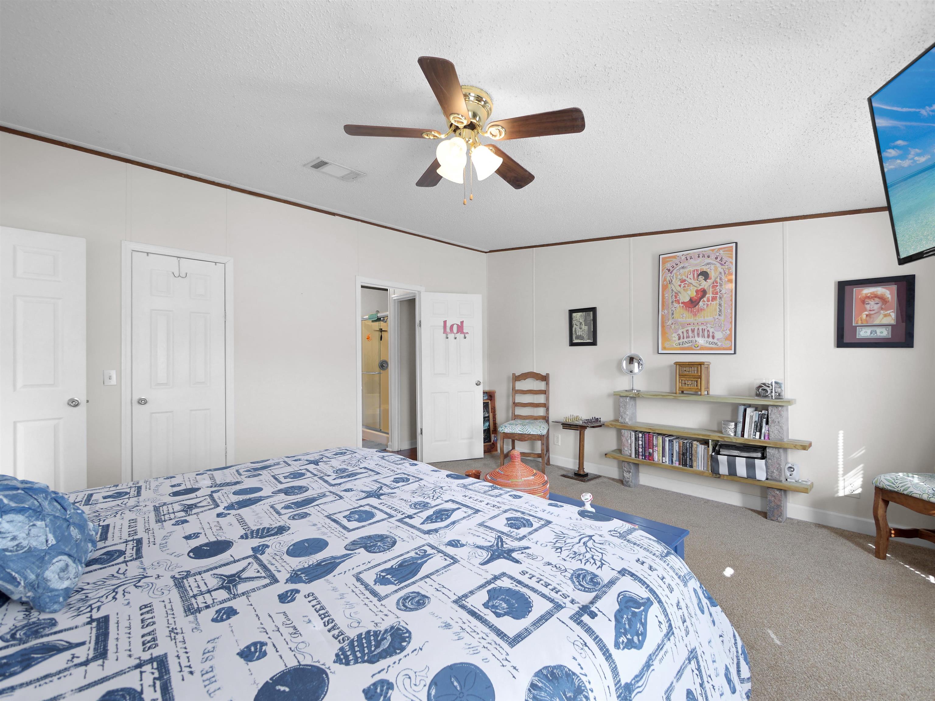 2961 Race Track Road St. Augustine, FL 32084 - Photo 16 of 42 a bedroom with a bed and a dresser