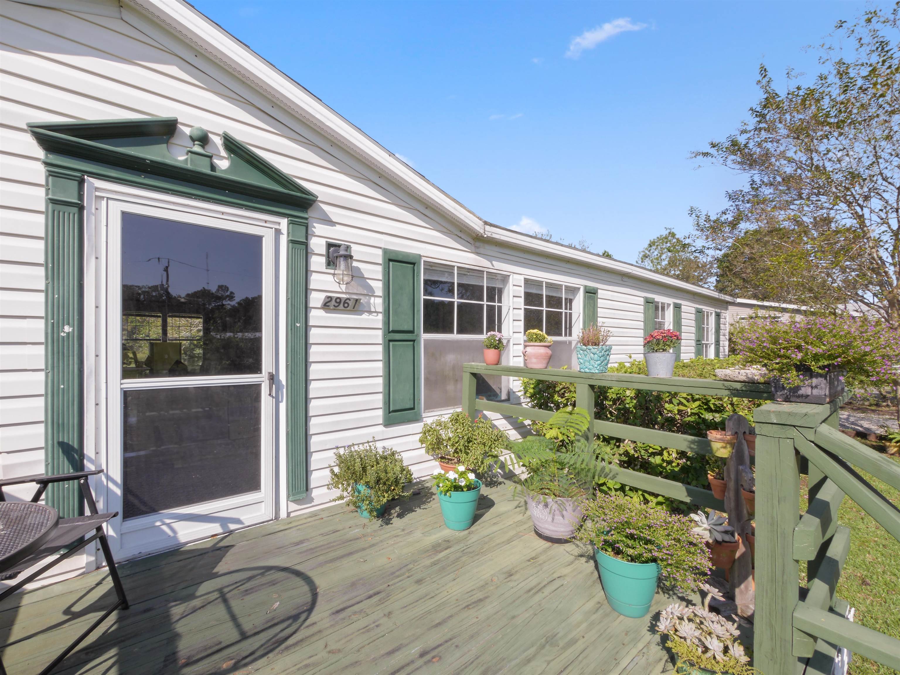 2961 Race Track Road St. Augustine, FL 32084 - Photo 2 of 42 a front view of a house with garden