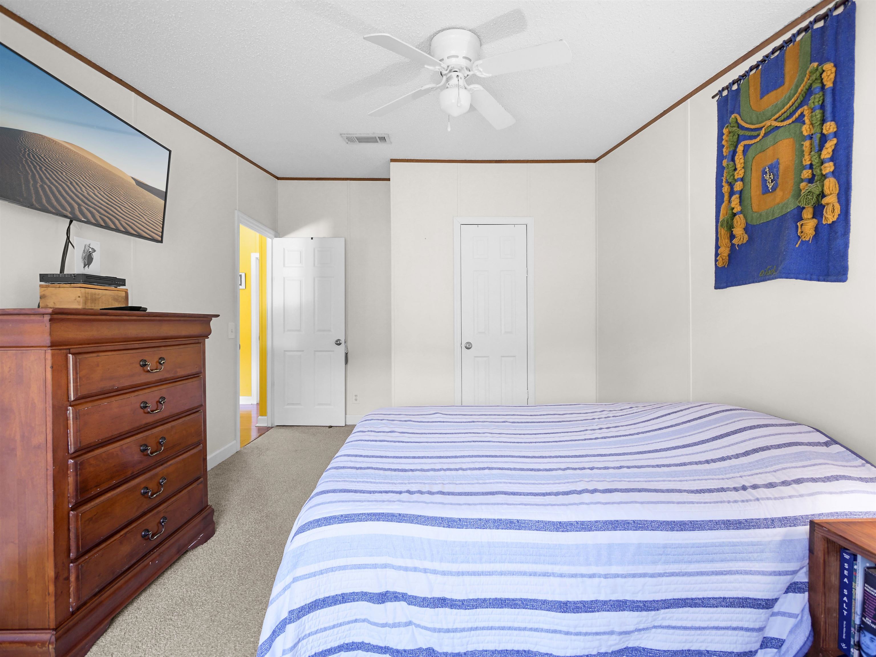 2961 Race Track Road St. Augustine, FL 32084 - Photo 21 of 42 a bedroom with a bed and a dresser