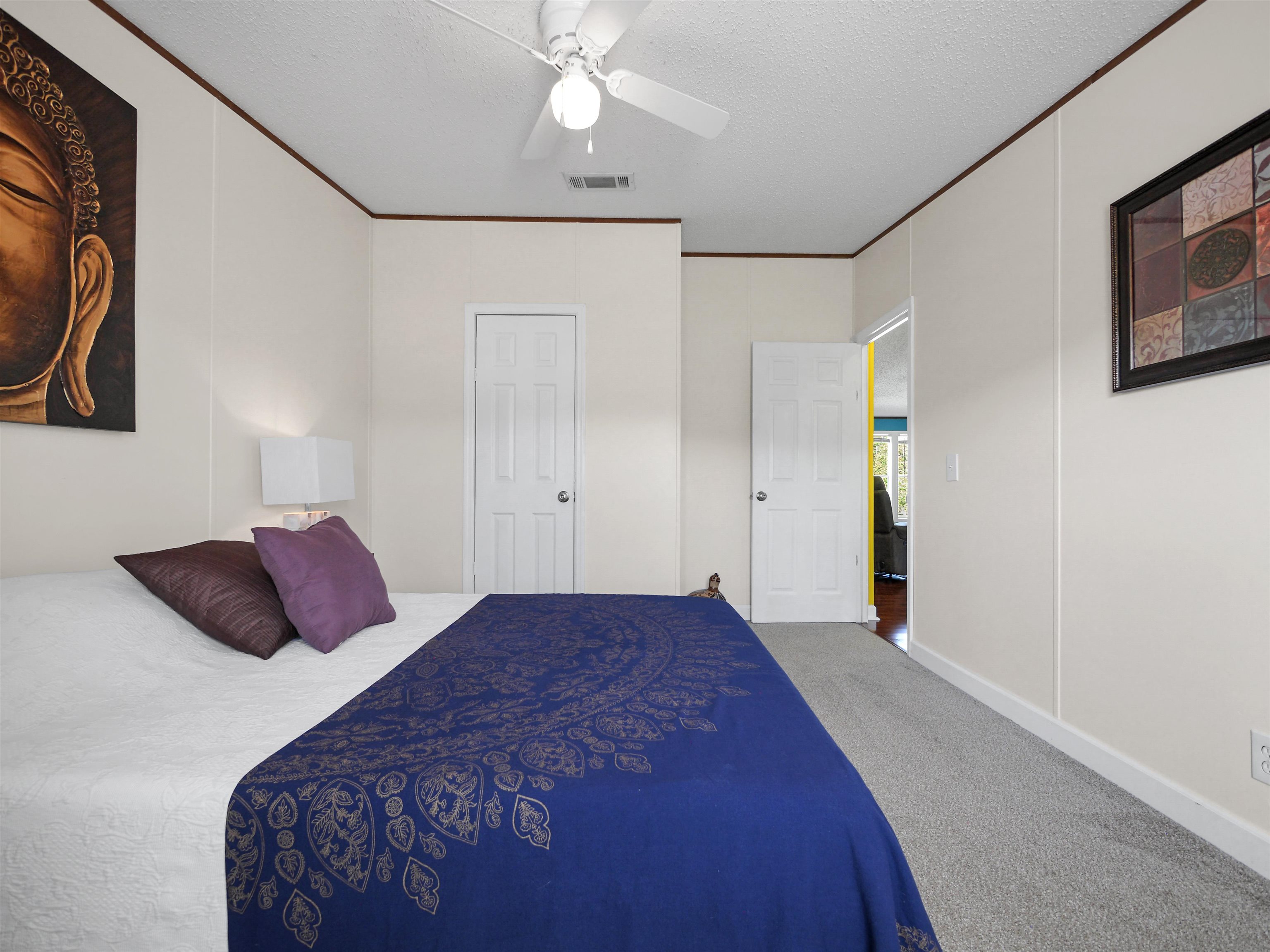2961 Race Track Road St. Augustine, FL 32084 - Photo 24 of 42 a bedroom with a large bed and a chandelier
