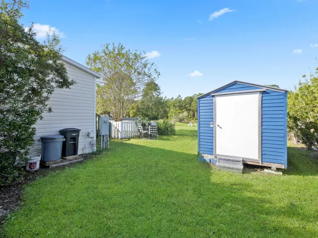a view of a green field and trees