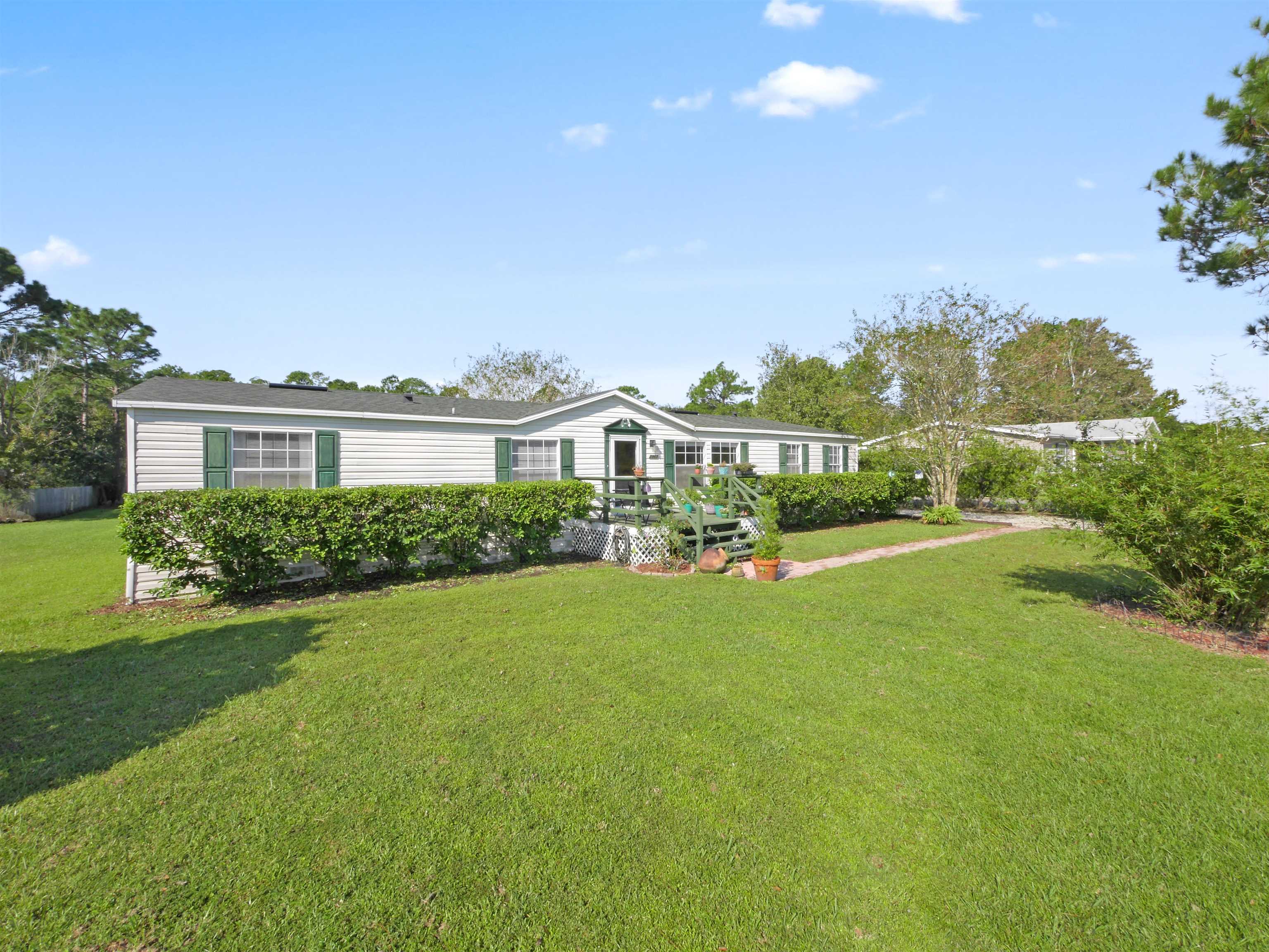 2961 Race Track Road St. Augustine, FL 32084 - Photo 36 of 42 a view of a house with a big yard and potted plants