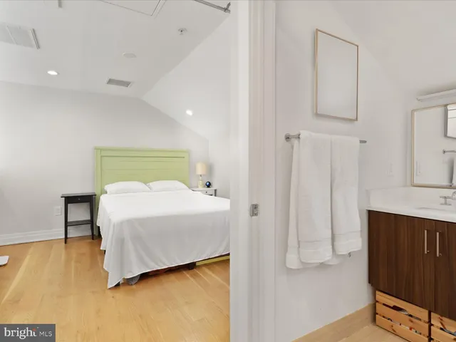 a bedroom with a bed and a night stand