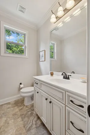 a kitchen with a sink cabinets and wooden floor