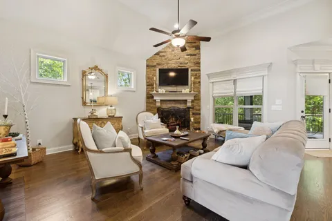 a living room with furniture a flat screen tv and a fireplace