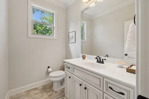 a kitchen with a sink stainless steel appliances and white cabinets