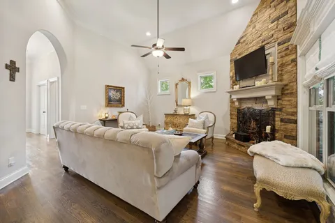 a living room with furniture a fireplace and a flat screen tv