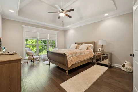 a bedroom with a bed and a chandelier