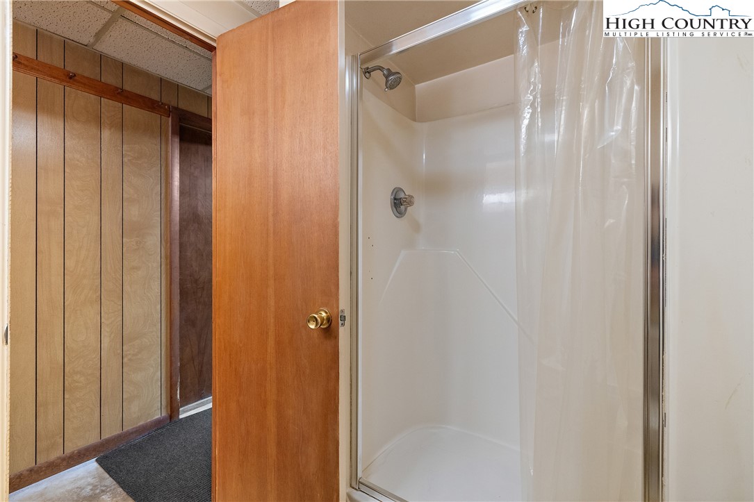 178 Green Knob Mountain Road Boone, NC 28607 - Photo 24 of 49 a bathroom with a glass shower door