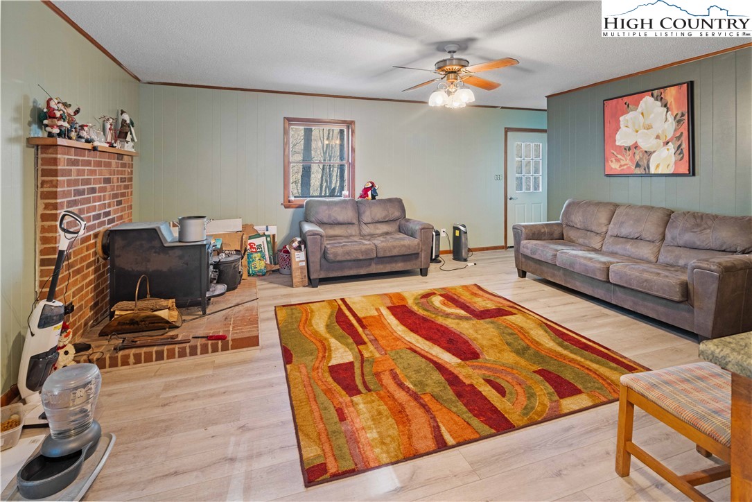 178 Green Knob Mountain Road Boone, NC 28607 - Photo 29 of 49 a living room with furniture a rug and a chandelier