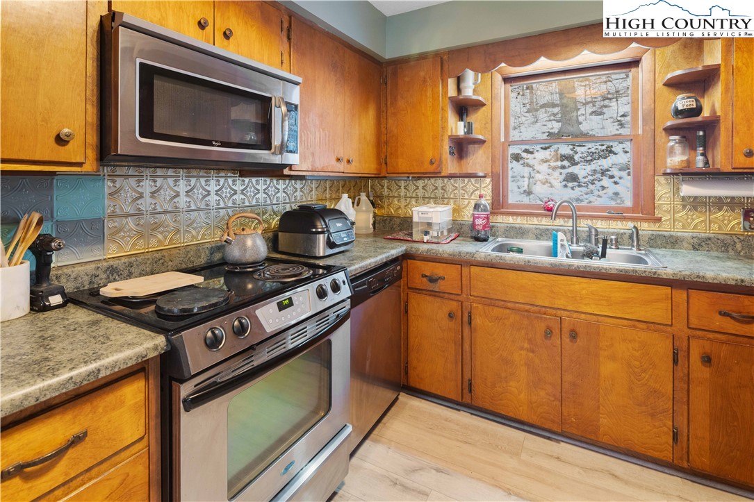 178 Green Knob Mountain Road Boone, NC 28607 - Photo 31 of 49 a kitchen with stainless steel appliances granite countertop a stove a sink and a microwave