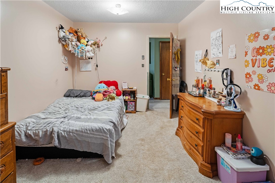 178 Green Knob Mountain Road Boone, NC 28607 - Photo 37 of 49 a bedroom with bed and a dresser