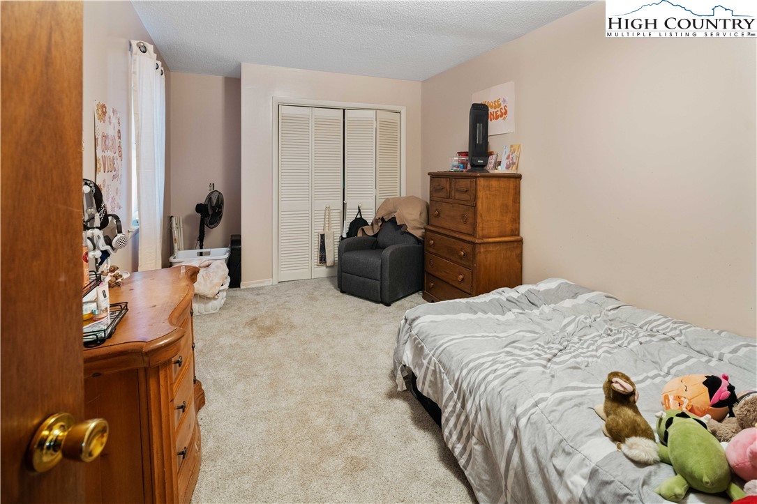 178 Green Knob Mountain Road Boone, NC 28607 - Photo 38 of 49 a bedroom with a bed and a couch