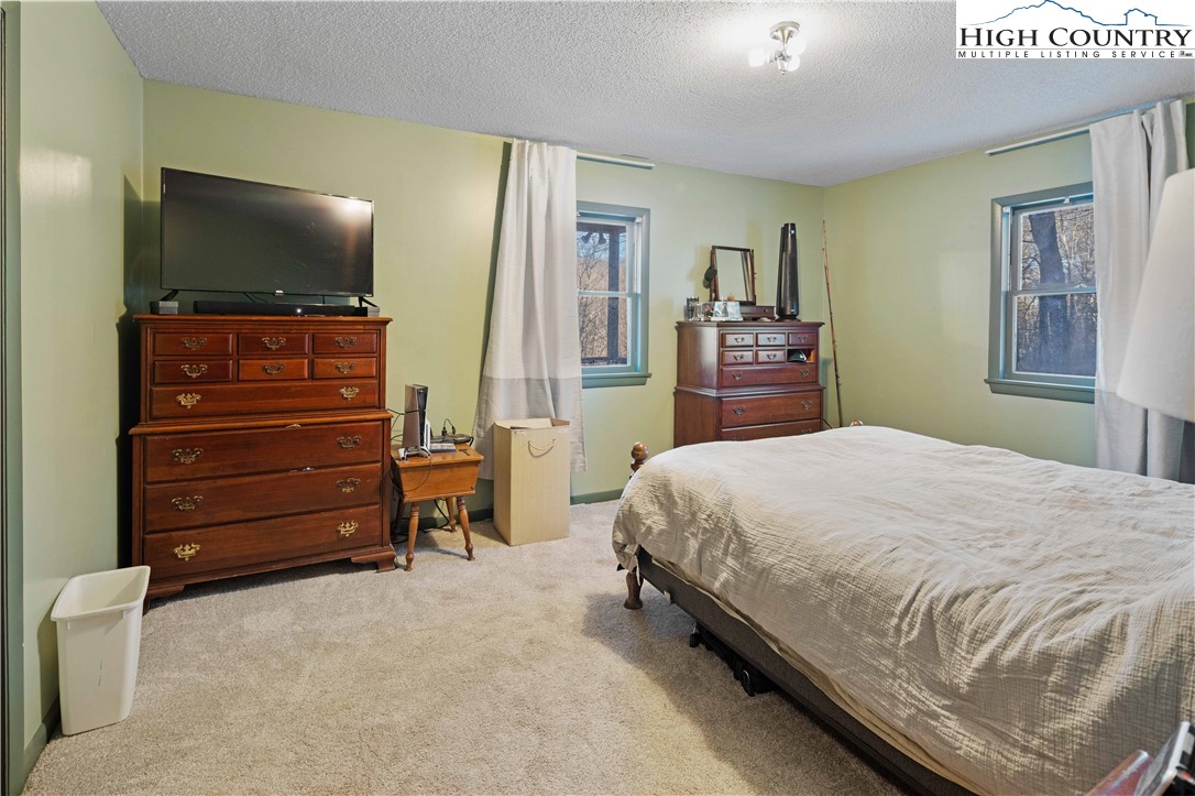 178 Green Knob Mountain Road Boone, NC 28607 - Photo 44 of 49 a bedroom with a bed and a flat screen tv