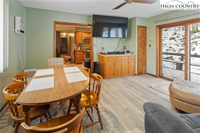a dining room with furniture and a window