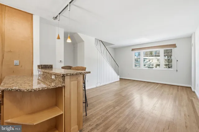 a view of a room with wooden floor and window