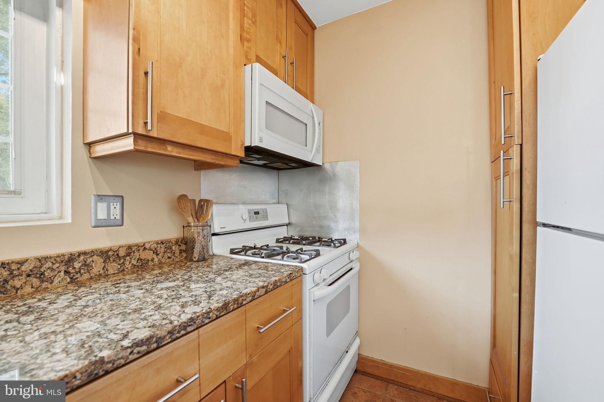 5364 Pooks Hill Road Bethesda, MD 20814 - Photo 9 of 20 a kitchen with stainless steel appliances granite countertop a sink and a stove