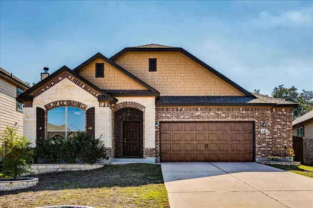 a front view of a house with garage