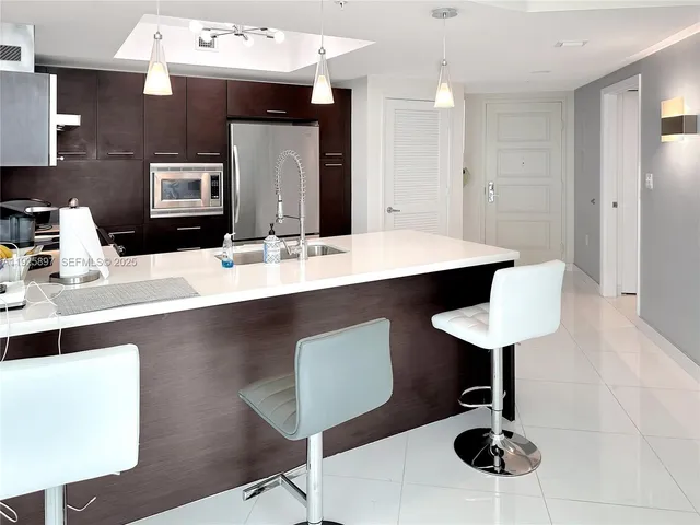 a kitchen with a counter space a sink and appliances