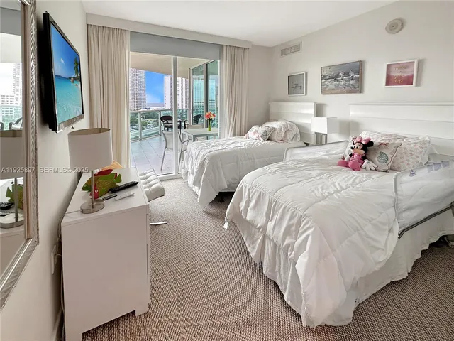 a bedroom with a bed and flat screen tv