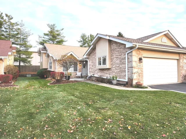 a view of a yard in front of a house with large trees