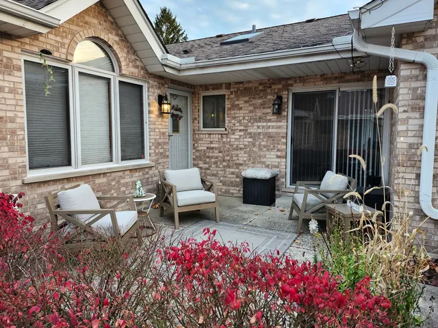 a front view of a house with outdoor seating