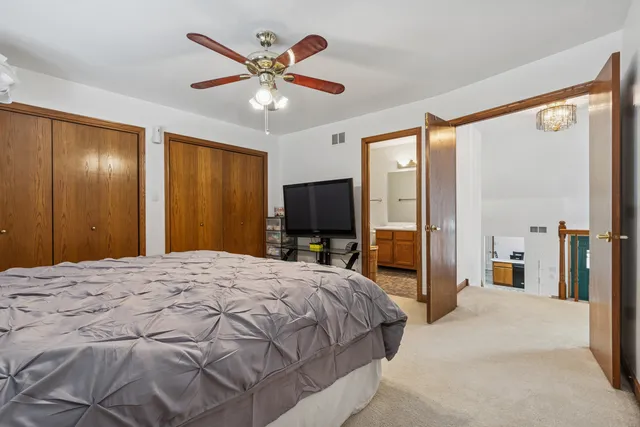 a bedroom with a large bed and a flat screen tv