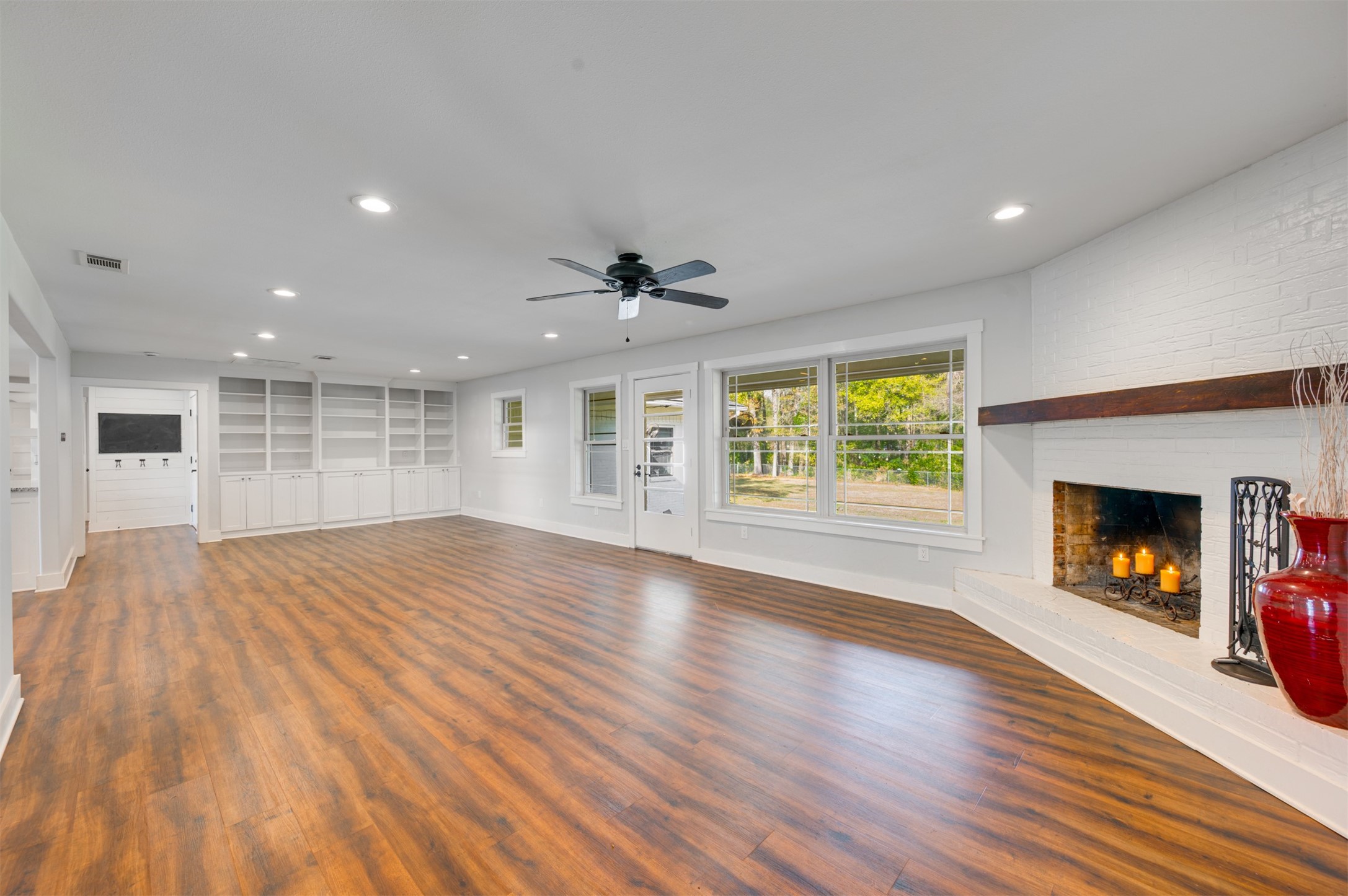 215 Perryman Road Lindale, TX 75771 - Photo 11 of 44 Living Area with Library Built Ins and Back Door and Large Picture Window overlooking Backyard