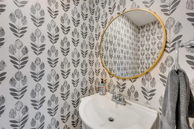 a view of a house with a yard chairs and floor to ceiling window