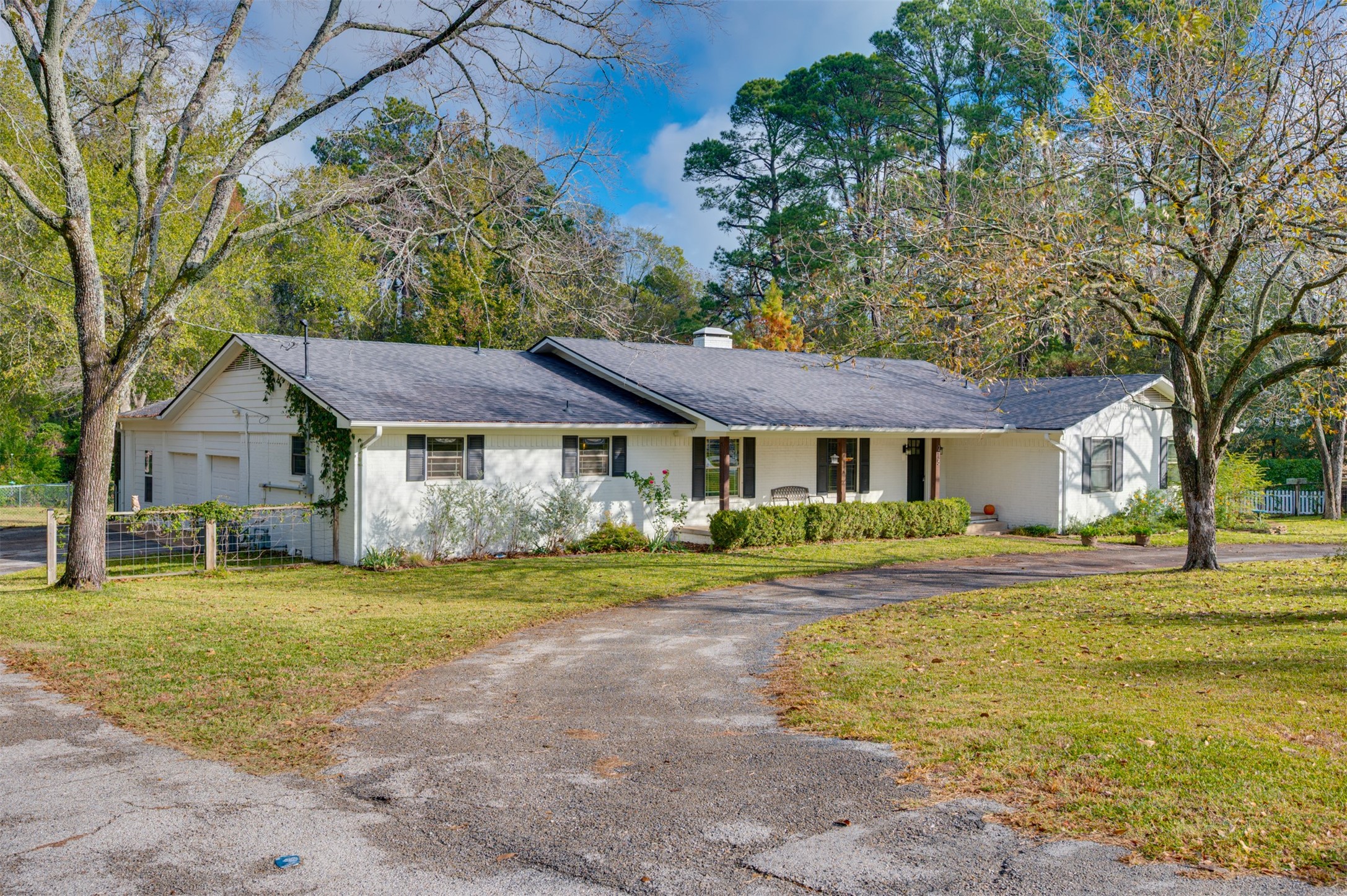 215 Perryman Road Lindale, TX 75771 - Photo 6 of 44 a front view of a house with a garden and trees