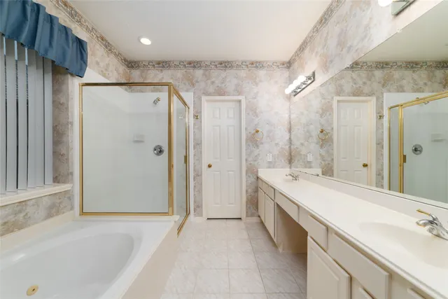 a spacious bathroom with a shower sink and mirror