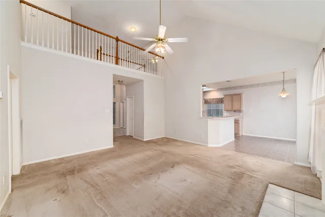 a view of empty room with wooden floor and ceiling fan