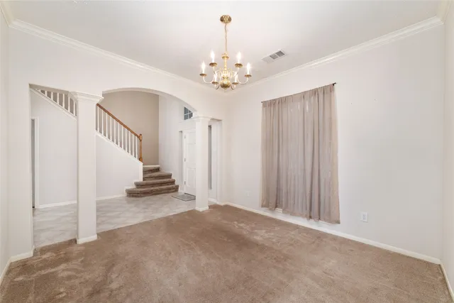 a view of an empty room with stairs