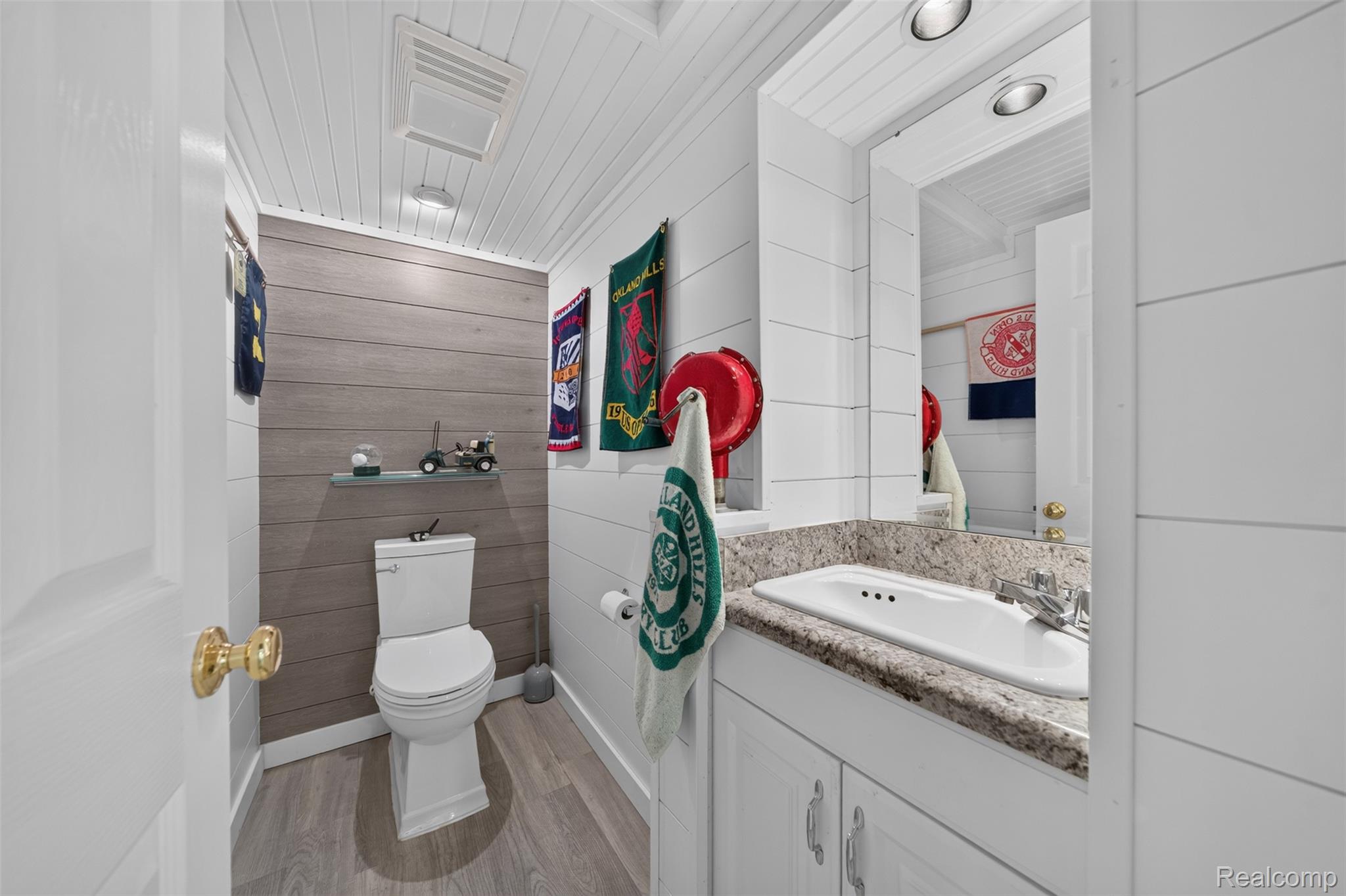 1236 Chaffer Drive Rochester, MI 48306 - Photo 46 of 76 Bathroom featuring wood-finish flooring, white shiplap walls, and a contrasting accent wall