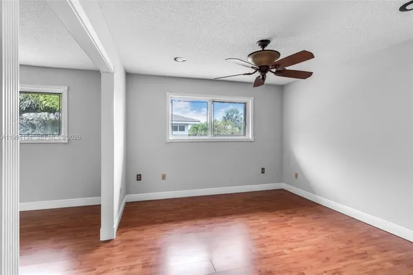 a view of room with hardwood floor and window