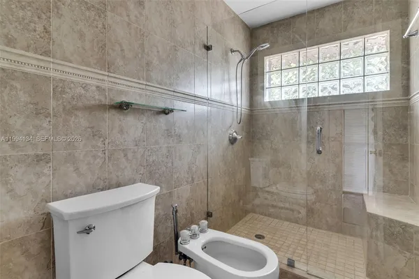a bathroom with a shower and a toilet