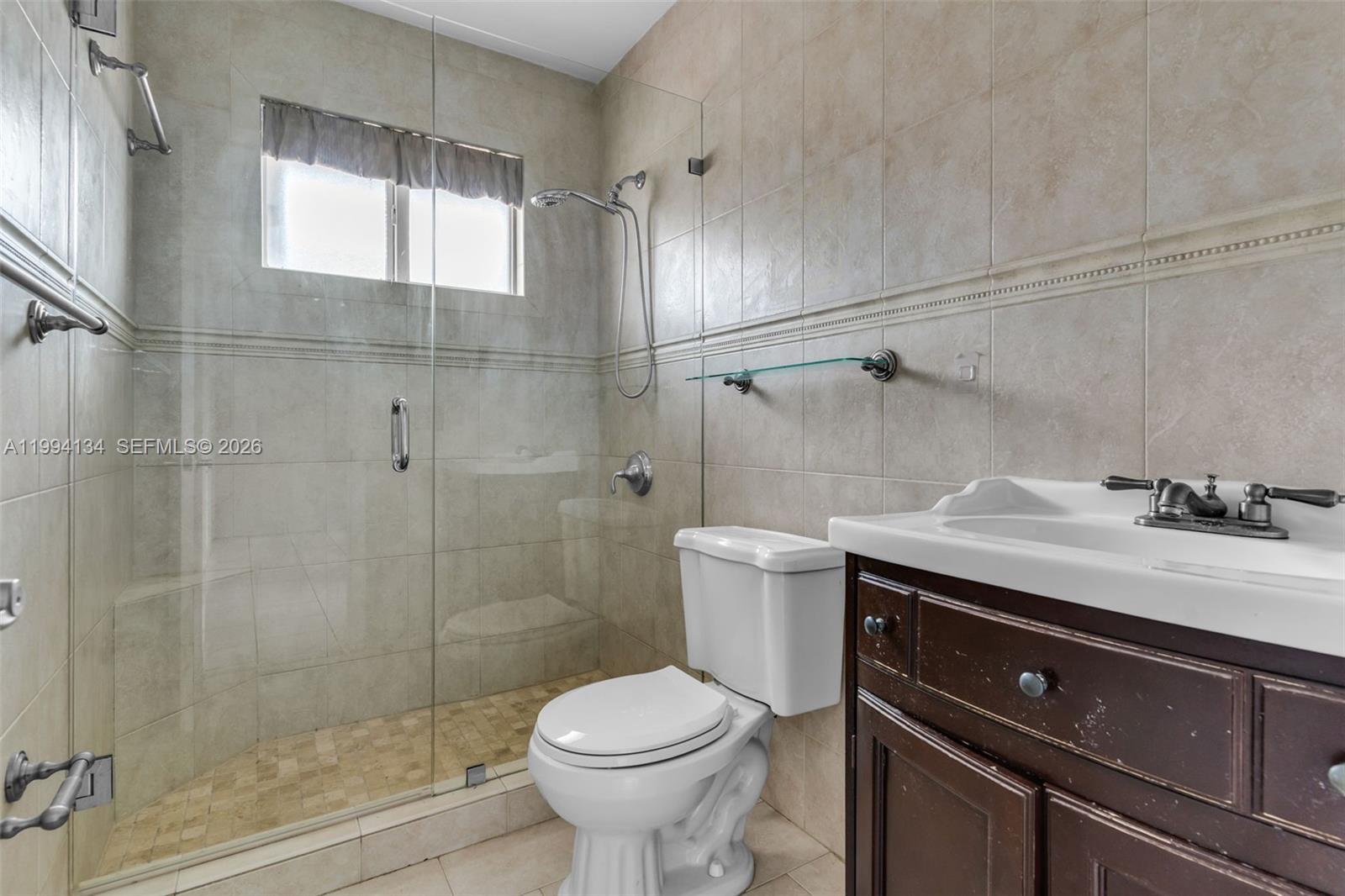 11319 Southwest 73rd Lane Miami, FL 33173 - Photo 22 of 43 a bathroom with a sink toilet and shower